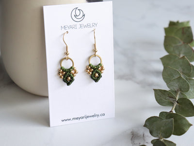 Pair of Green Arya macrame earrings made from raw brass.