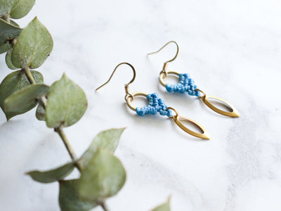 Side View of Marquise style drop macrame earrings in blue and golden color.