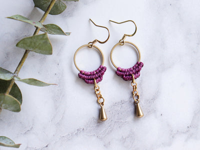 Closeup of Simple drop macrame earrings in purple color with white background.